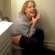 A girl is seen sitting on a toilet. She says that she is only peeing, but who knows?